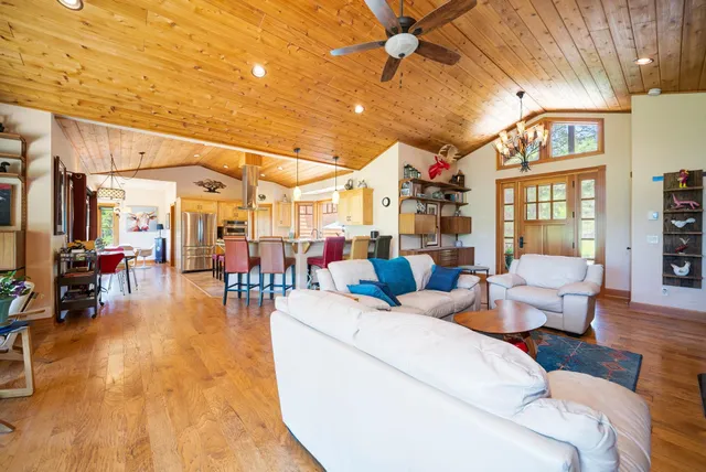 a living room with furniture and a chandelier
