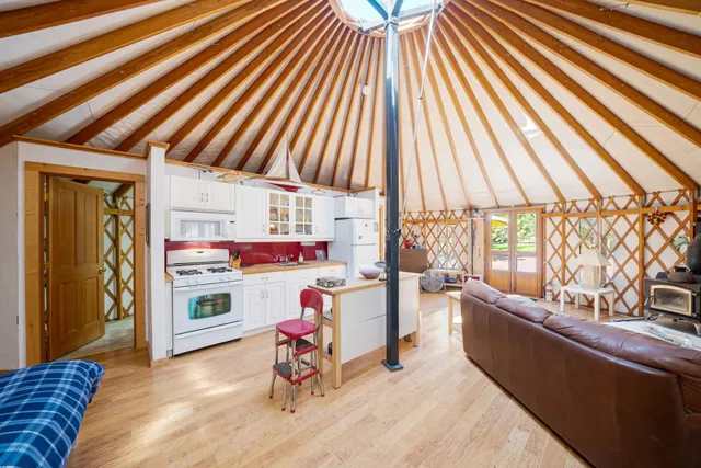 a view of a patio with table and chairs with wooden floor and fence