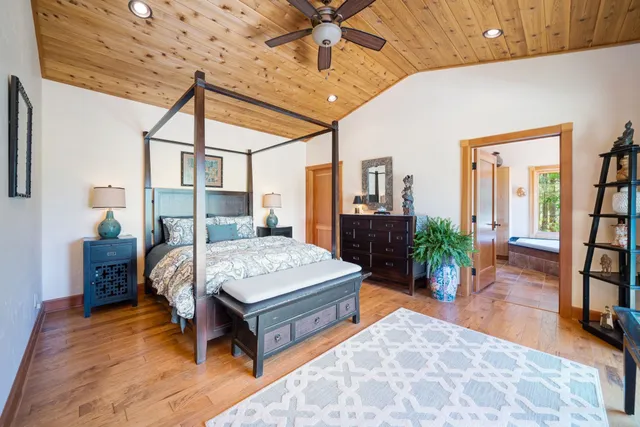 a bedroom with a bed bookshelf and a table