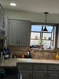 a kitchen with a sink cabinets and window