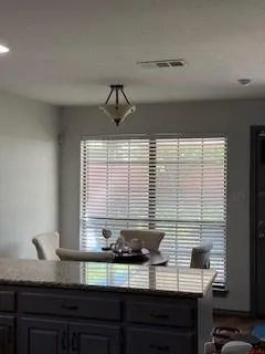 a kitchen with a window and cabinets