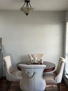 a view of a room with furniture and wooden floor