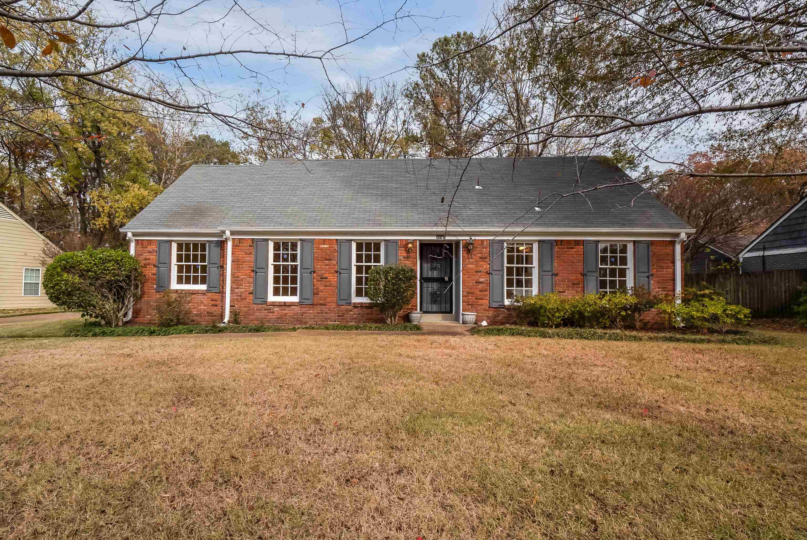 5500 Quince Road Memphis, TN 38119 - Photo 1 of 31 a front view of a house with a garden