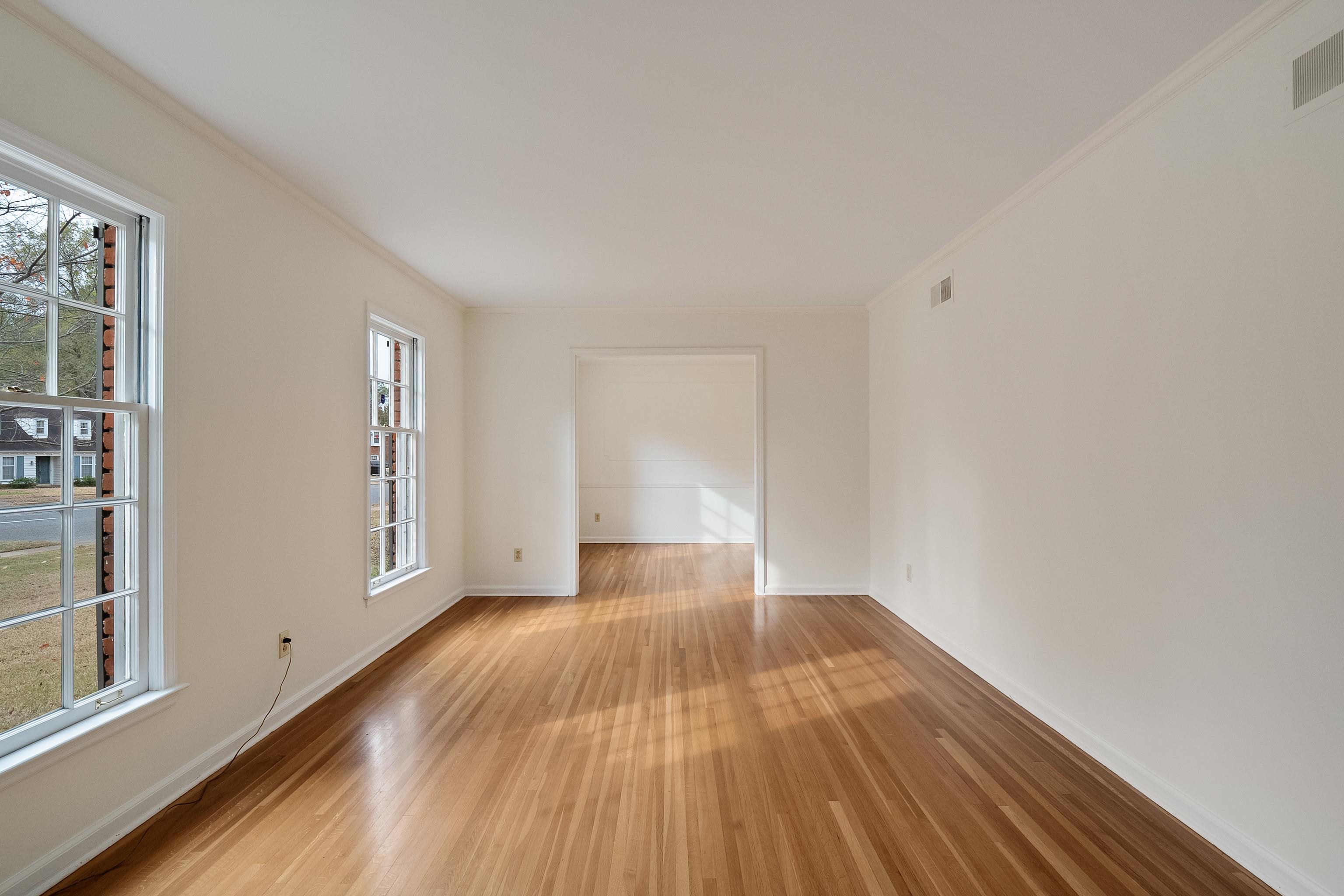 5500 Quince Road Memphis, TN 38119 - Photo 6 of 31 a view of an empty room with wooden floor and a window