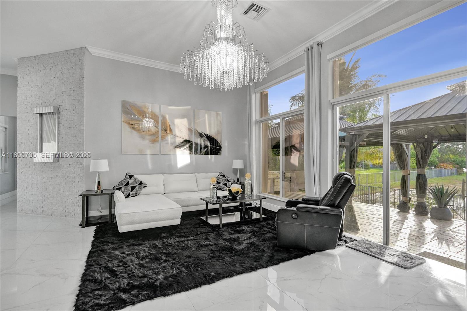 4248 Southwest 185th Avenue Miramar, FL 33029 - Photo 13 of 88 a living room with furniture chandelier and a chandelier