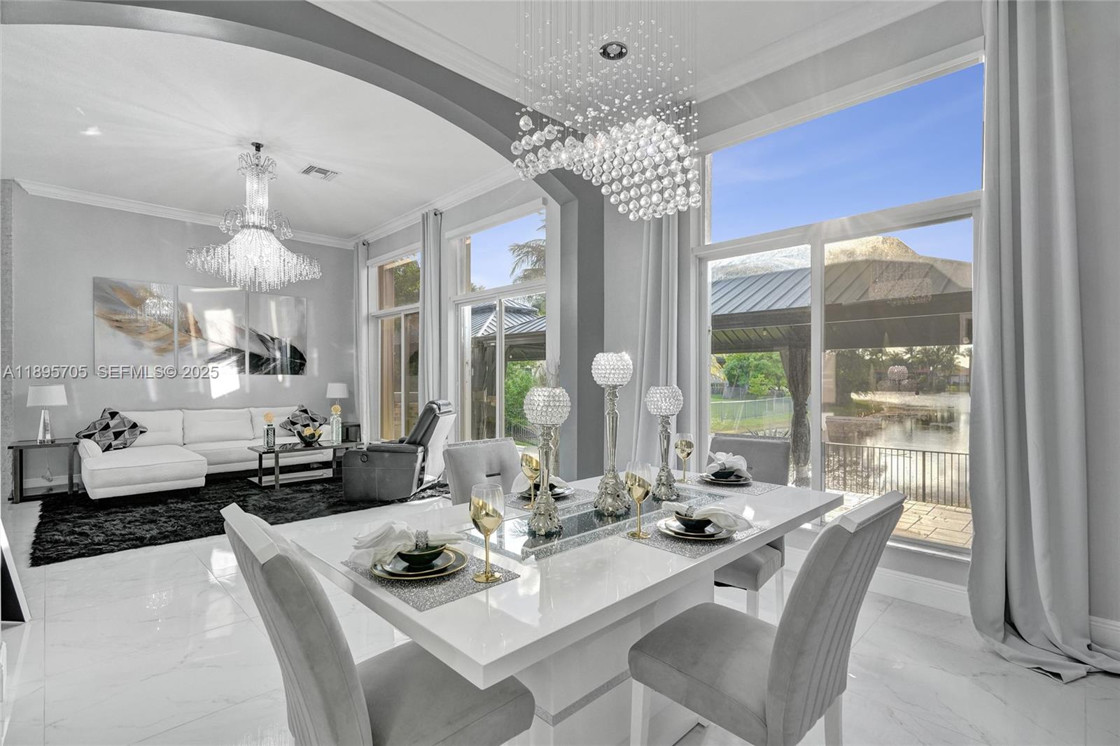 4248 Southwest 185th Avenue Miramar, FL 33029 - Photo 16 of 88 a view of a dining room with furniture wooden floor and chandelier
