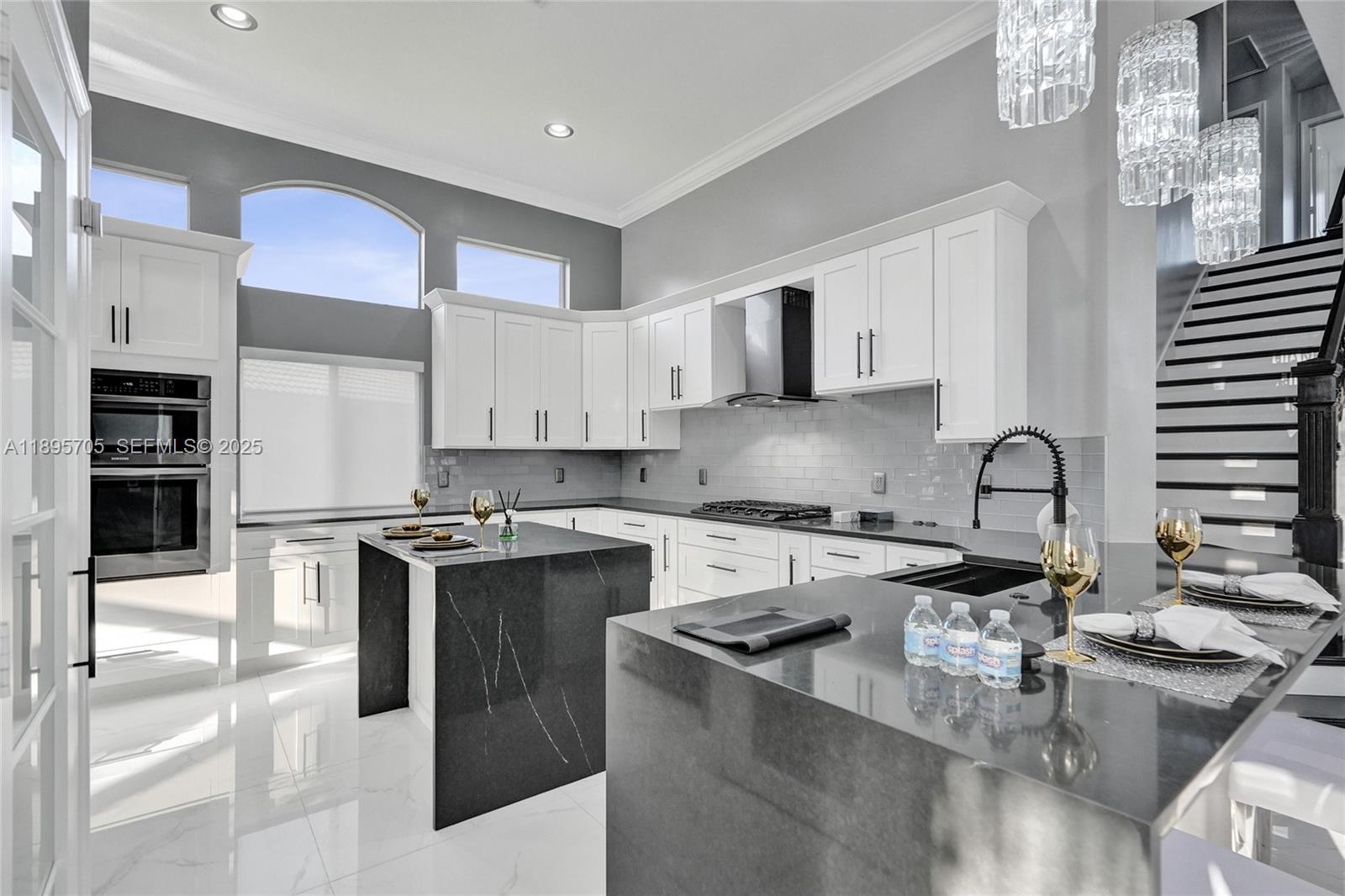 4248 Southwest 185th Avenue Miramar, FL 33029 - Photo 19 of 88 a kitchen with stainless steel appliances granite countertop a stove top oven a sink a stove and a refrigerator