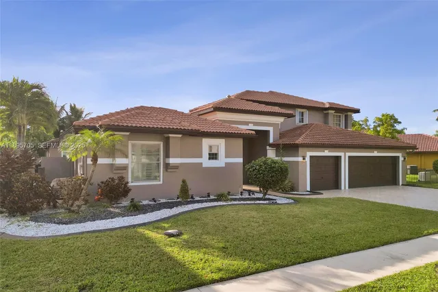 a front view of a house with a yard and garage