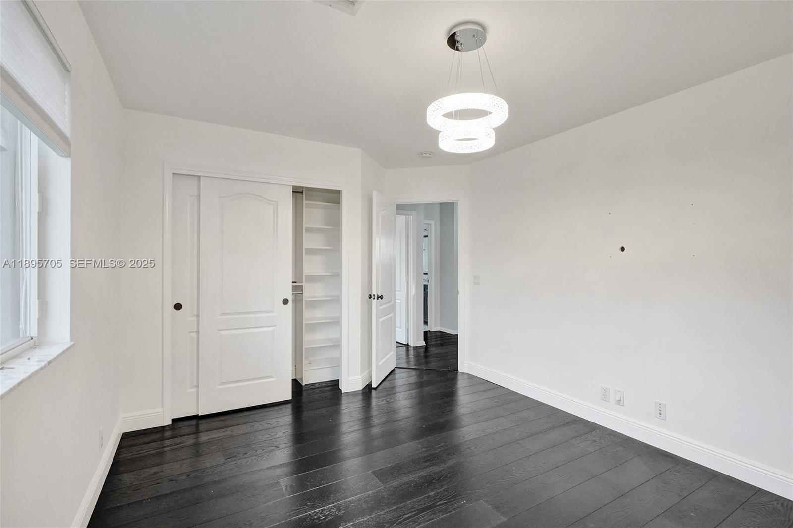 4248 Southwest 185th Avenue Miramar, FL 33029 - Photo 54 of 88 an empty room with wooden floor and windows