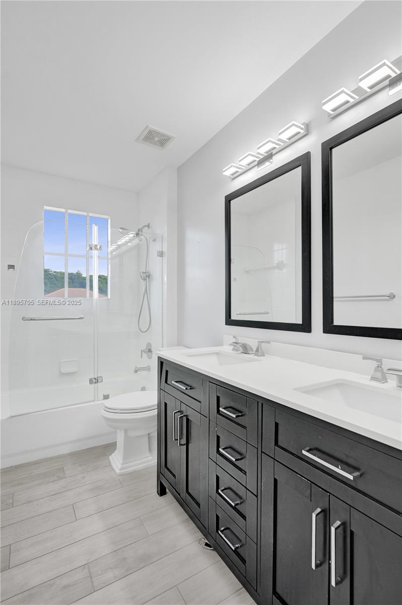 4248 Southwest 185th Avenue Miramar, FL 33029 - Photo 55 of 88 a bathroom with a sink a toilet and mirror