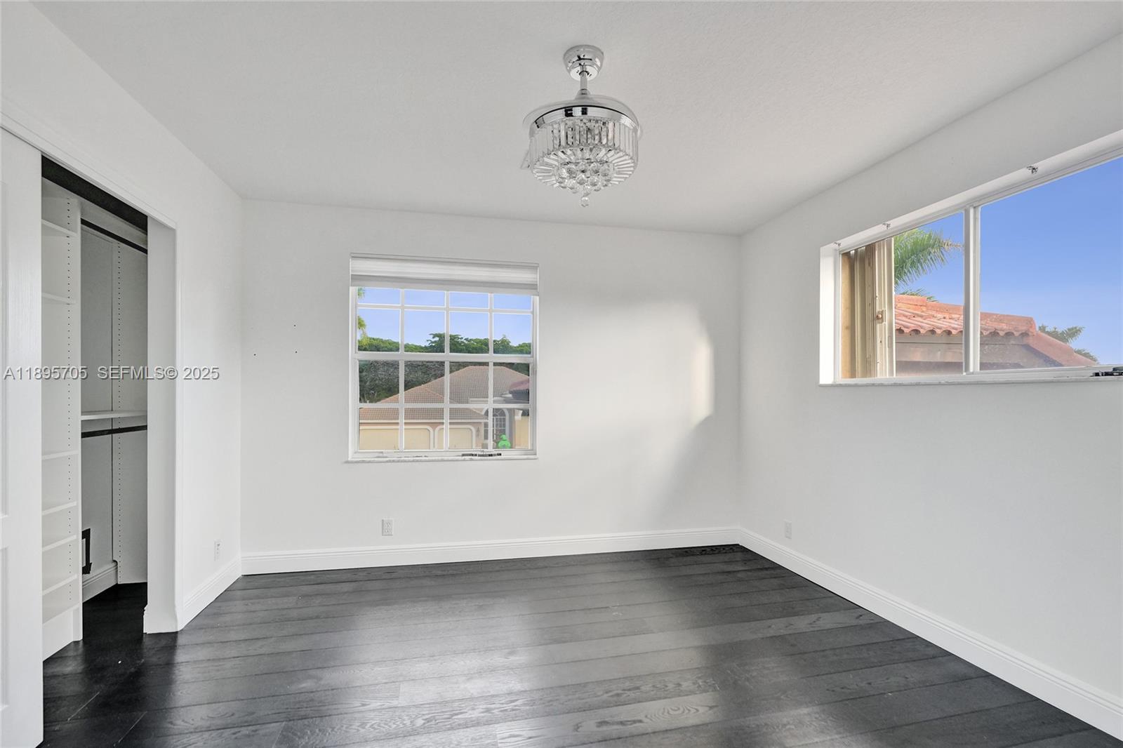 4248 Southwest 185th Avenue Miramar, FL 33029 - Photo 57 of 88 a view of an empty room with wooden floor and a window