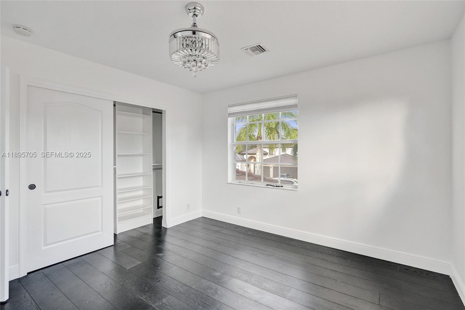 4248 Southwest 185th Avenue Miramar, FL 33029 - Photo 58 of 88 an empty room with wooden floor and windows