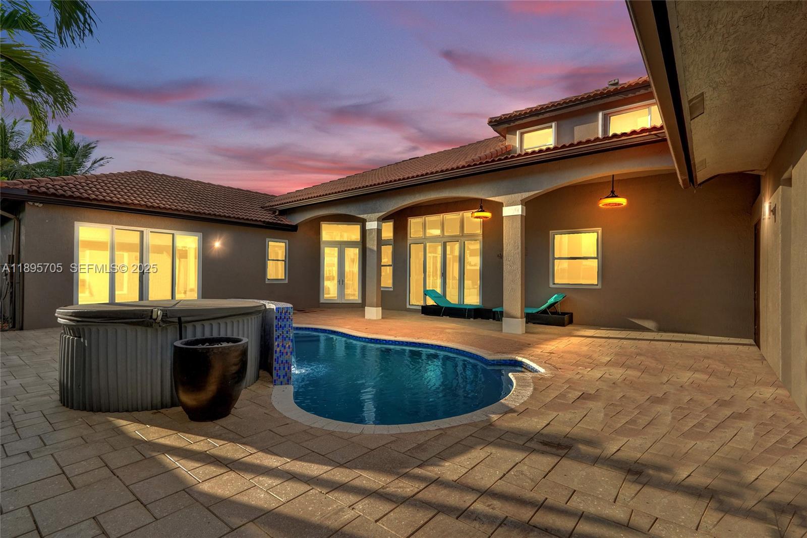 4248 Southwest 185th Avenue Miramar, FL 33029 - Photo 7 of 88 a view of a house with a swimming pool and sitting area