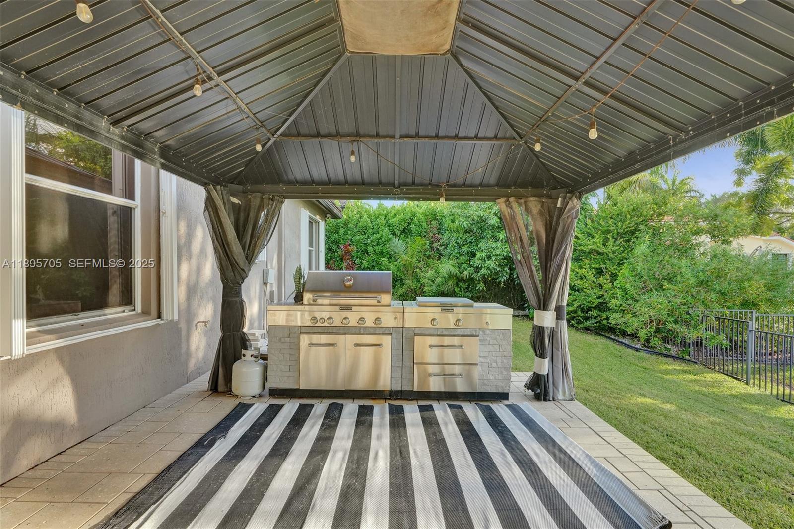 4248 Southwest 185th Avenue Miramar, FL 33029 - Photo 74 of 88 a view of a roof deck with wooden floor and fence