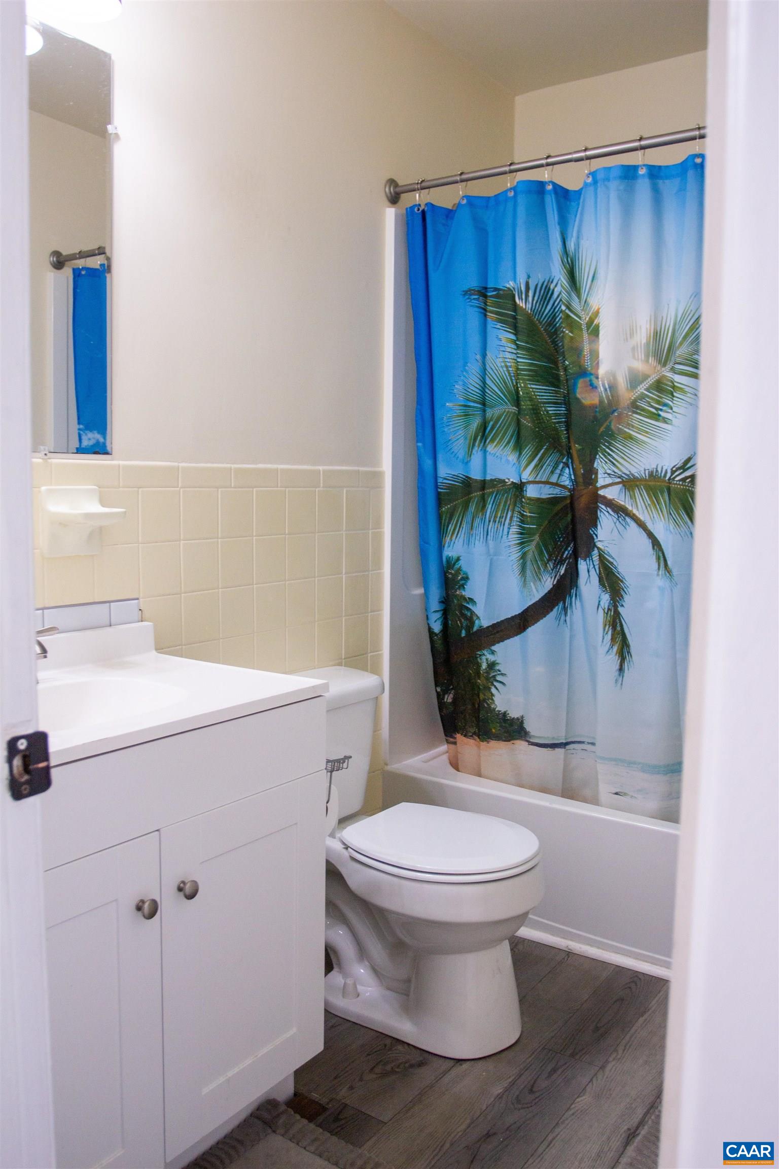 2527 Hydraulic Road, Unit 34 Charlottesville, VA 22901 - Photo 7 of 10 a bathroom with a toilet a sink and tub