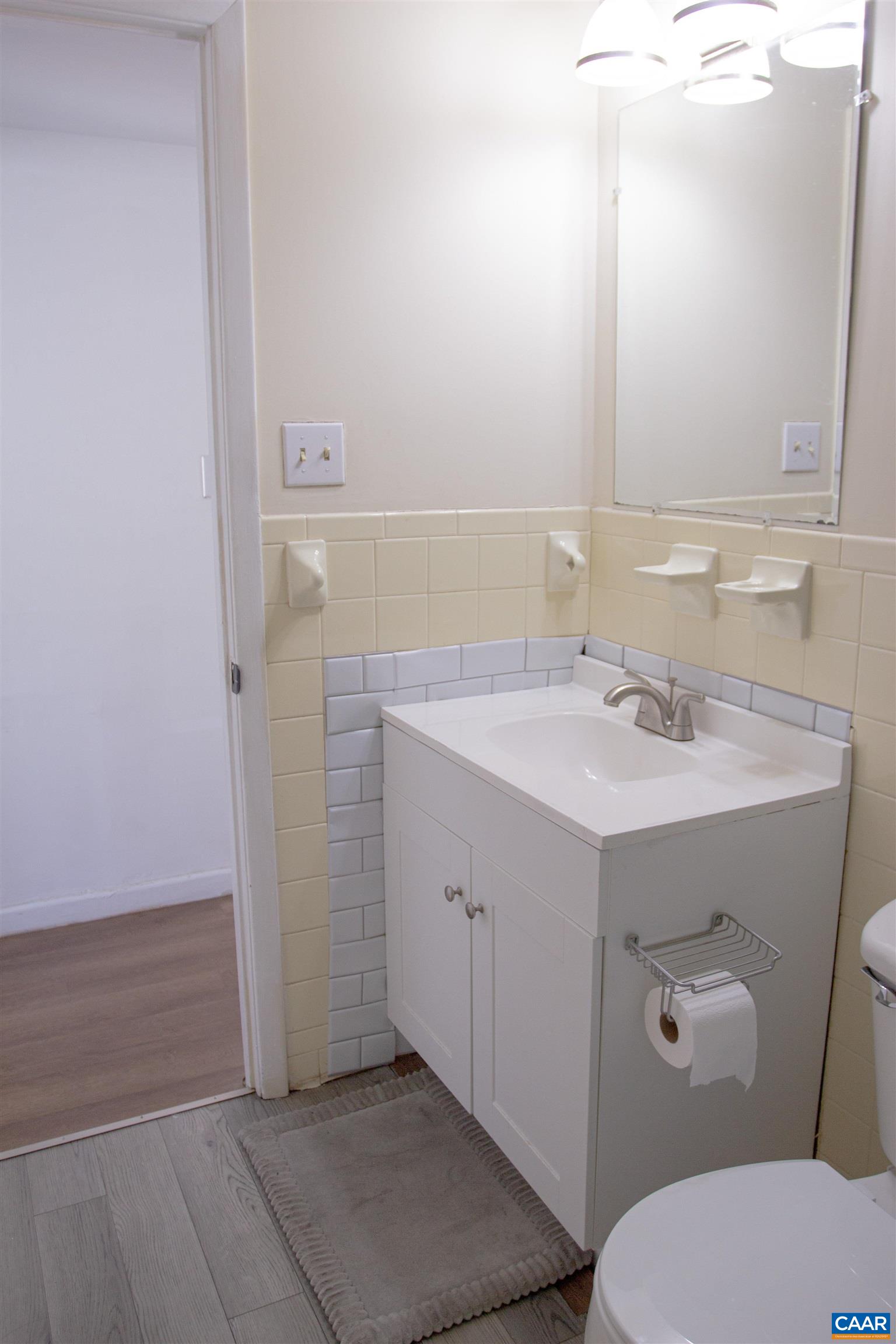 2527 Hydraulic Road, Unit 34 Charlottesville, VA 22901 - Photo 8 of 10 a bathroom with a sink toilet and mirror