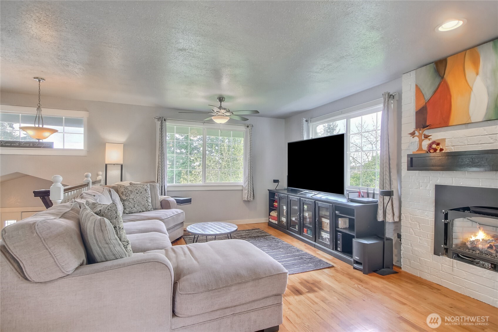7417 South Prospect Street Tacoma, WA 98409 - Photo 2 of 35 a living room with furniture and a flat screen tv