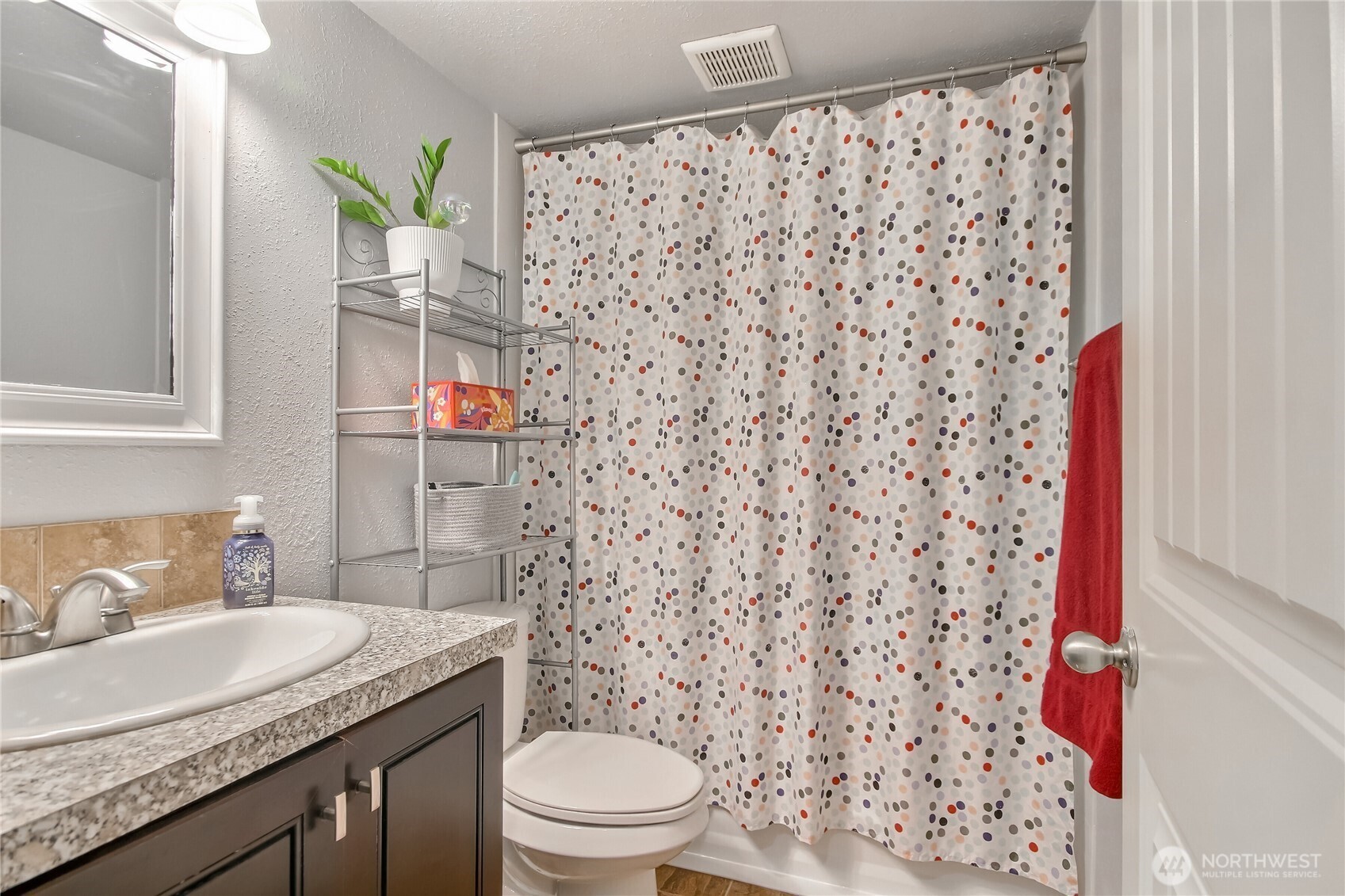 7417 South Prospect Street Tacoma, WA 98409 - Photo 23 of 35 a bathroom with a granite countertop sink and a toilet