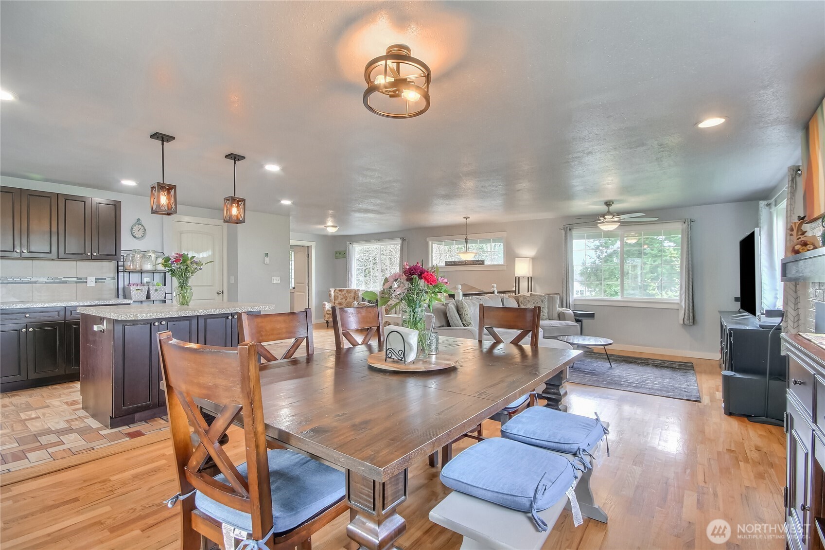 7417 South Prospect Street Tacoma, WA 98409 - Photo 9 of 35 a view of a dining room with furniture a kitchen and chandelier