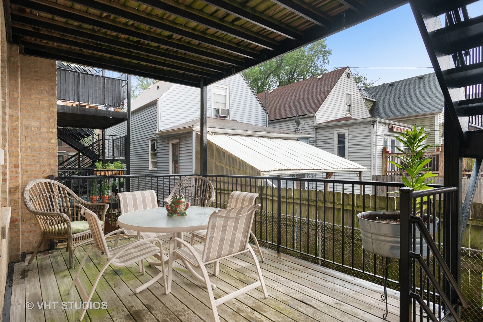 3339 West Byron Street, Unit 1 Chicago, IL 60618 - Photo 12 of 12 a patio with glass top table and chairs