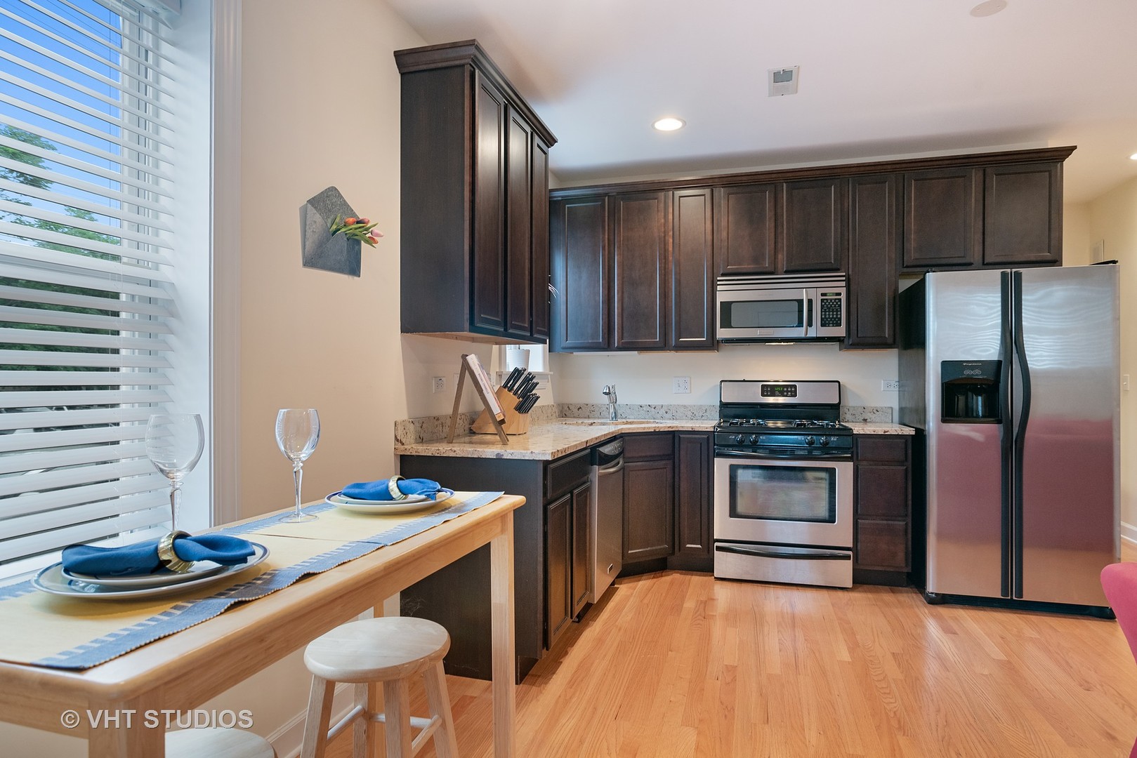 3339 West Byron Street, Unit 1 Chicago, IL 60618 - Photo 6 of 12 a kitchen with stainless steel appliances granite countertop a sink stove and refrigerator