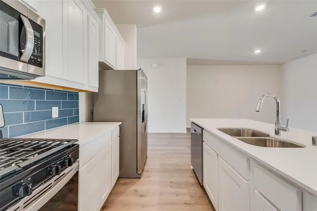 a kitchen that has a sink and a stove
