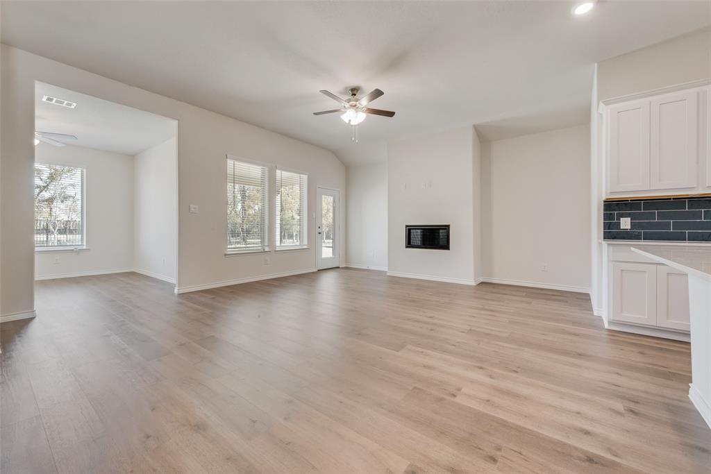 1532 Ruby Jewel Lane Anna, TX 75409 - Photo 9 of 19 a view of a livingroom with a ceiling fan window and wooden floor