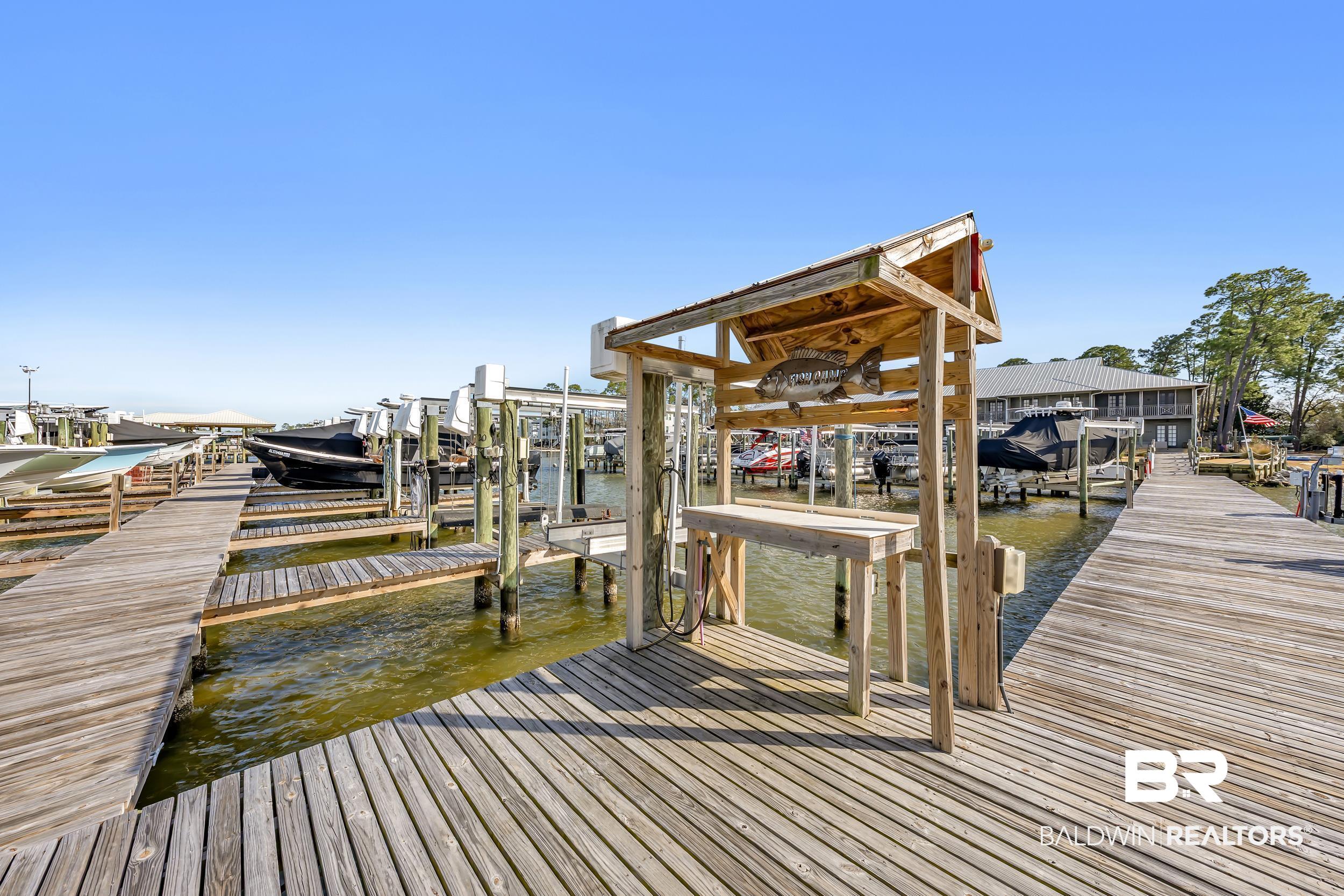 25773 Canal Road, Unit 32 Orange Beach, AL 36561 - Photo 29 of 35 Dock area featuring boat lift and a water view