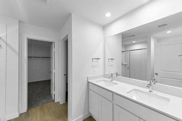 a bathroom with a shower and a glass door
