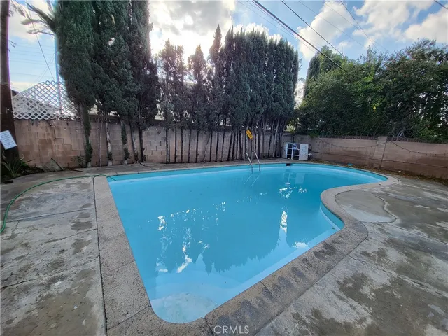 a view of a swimming pool with a backyard