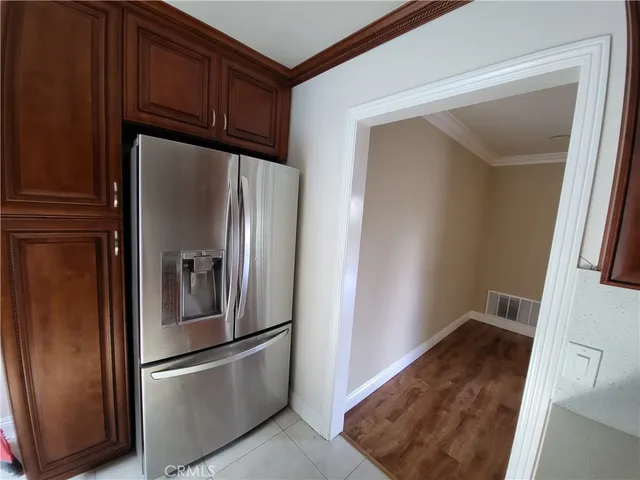 a metallic refrigerator freezer sitting in a kitchen