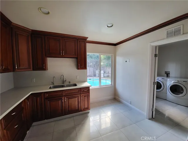 a kitchen with a sink a stove and cabinets