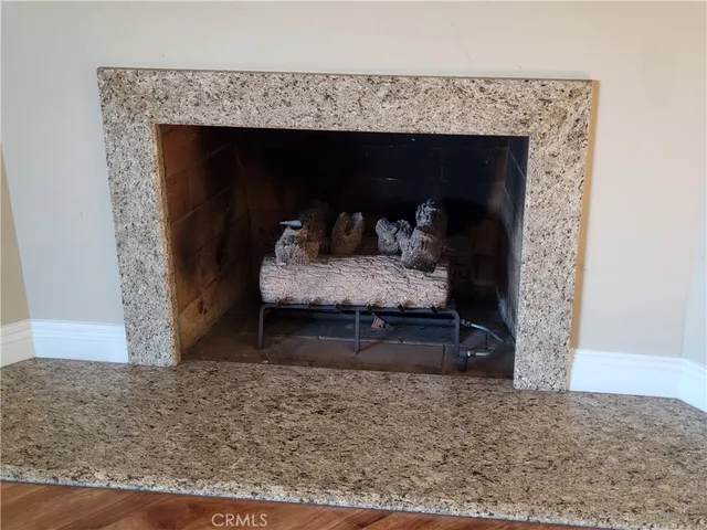 a room with a fireplace and a rug