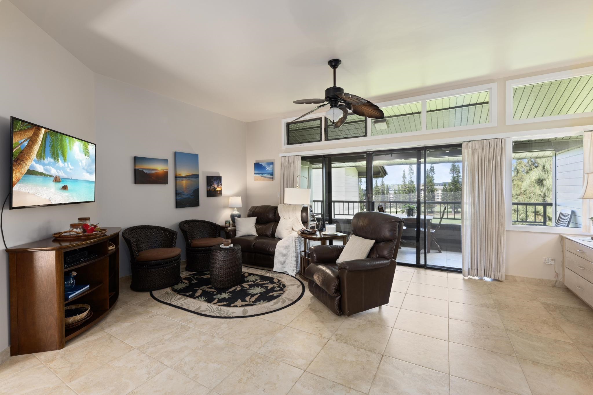 100 Ridge Road, Unit 723 Lahaina, HI 96761 - Photo 14 of 48 a living room with furniture a flat screen tv and large windows