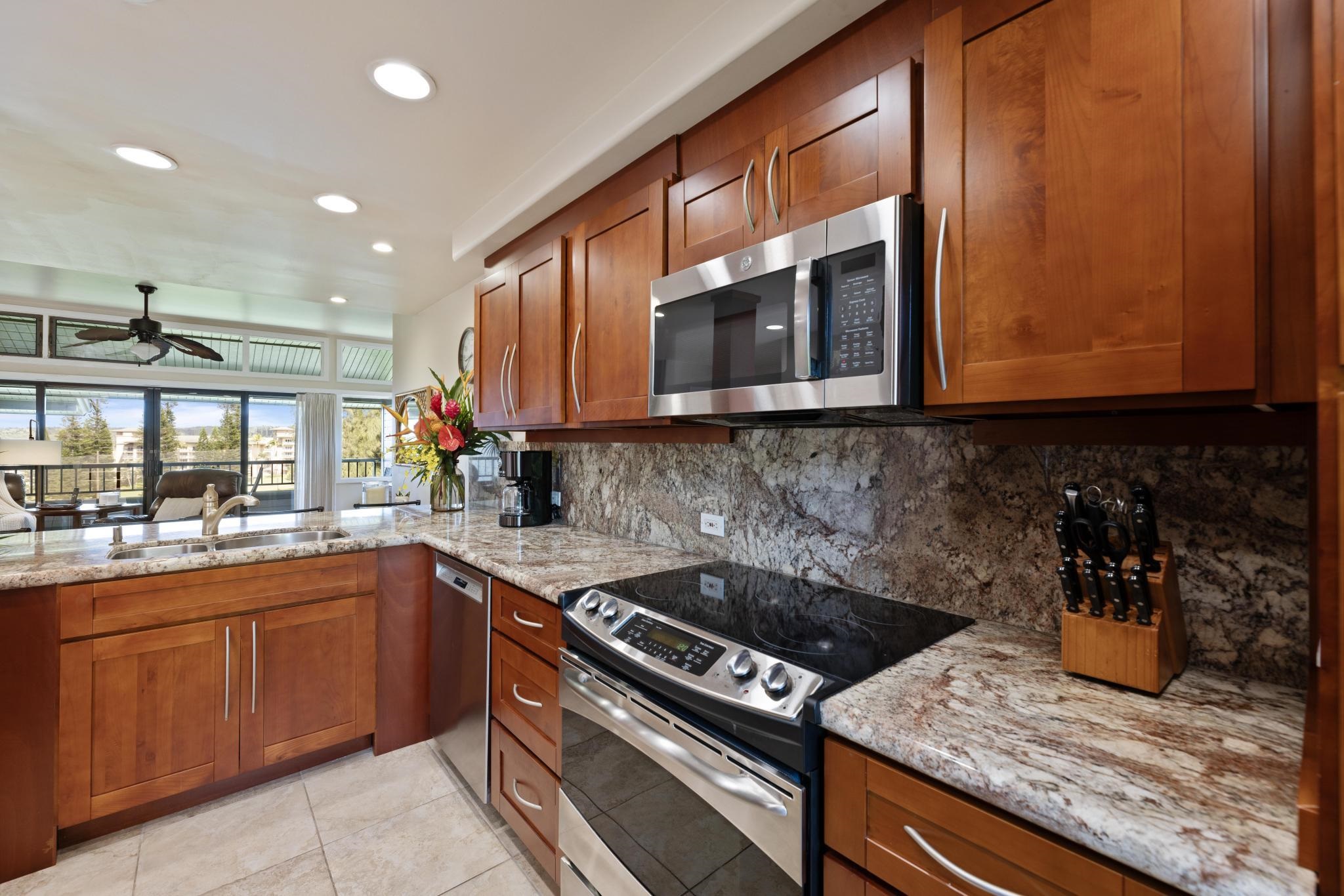 100 Ridge Road, Unit 723 Lahaina, HI 96761 - Photo 2 of 48 a kitchen with a sink a stove and cabinets