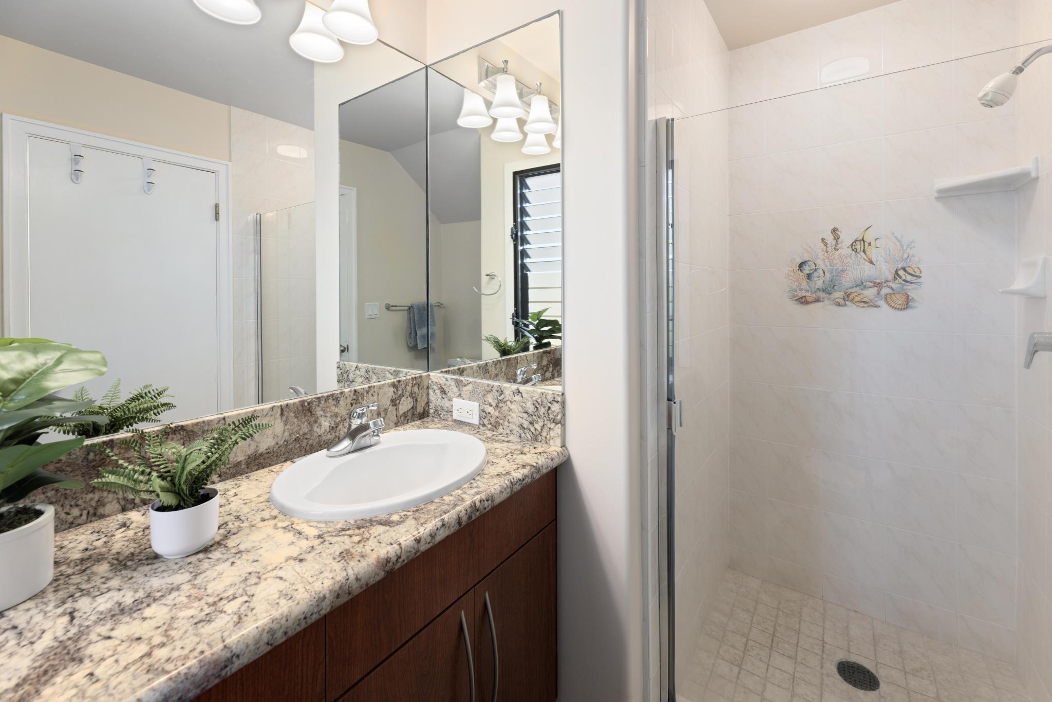100 Ridge Road, Unit 723 Lahaina, HI 96761 - Photo 32 of 48 a bathroom with a granite countertop sink a mirror and a shower