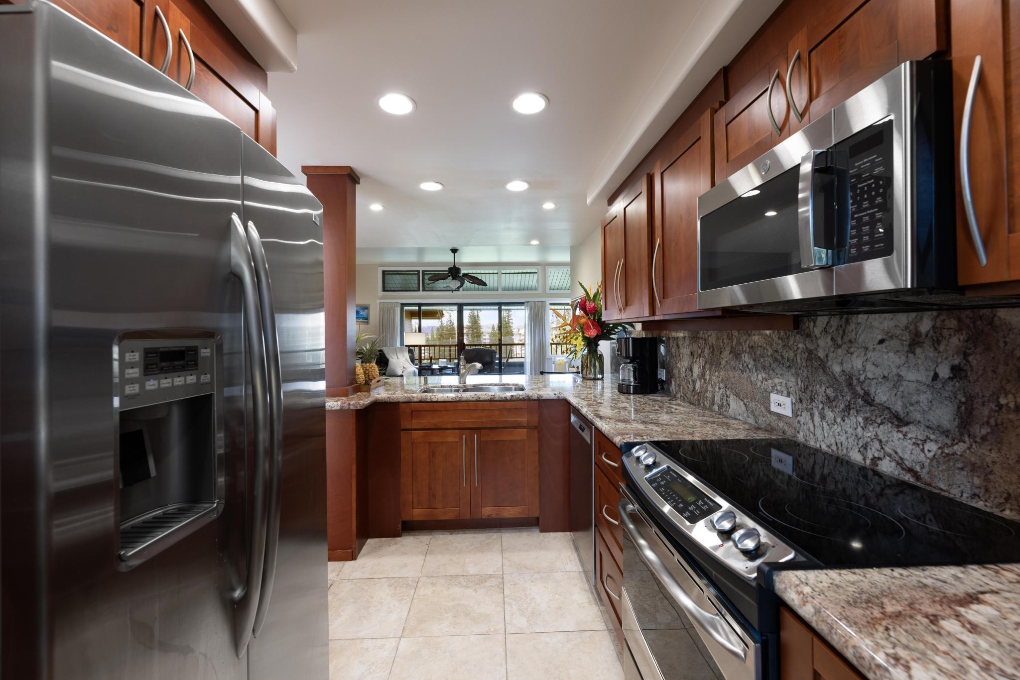 100 Ridge Road, Unit 723 Lahaina, HI 96761 - Photo 5 of 48 a kitchen with stainless steel appliances granite countertop a sink and stove