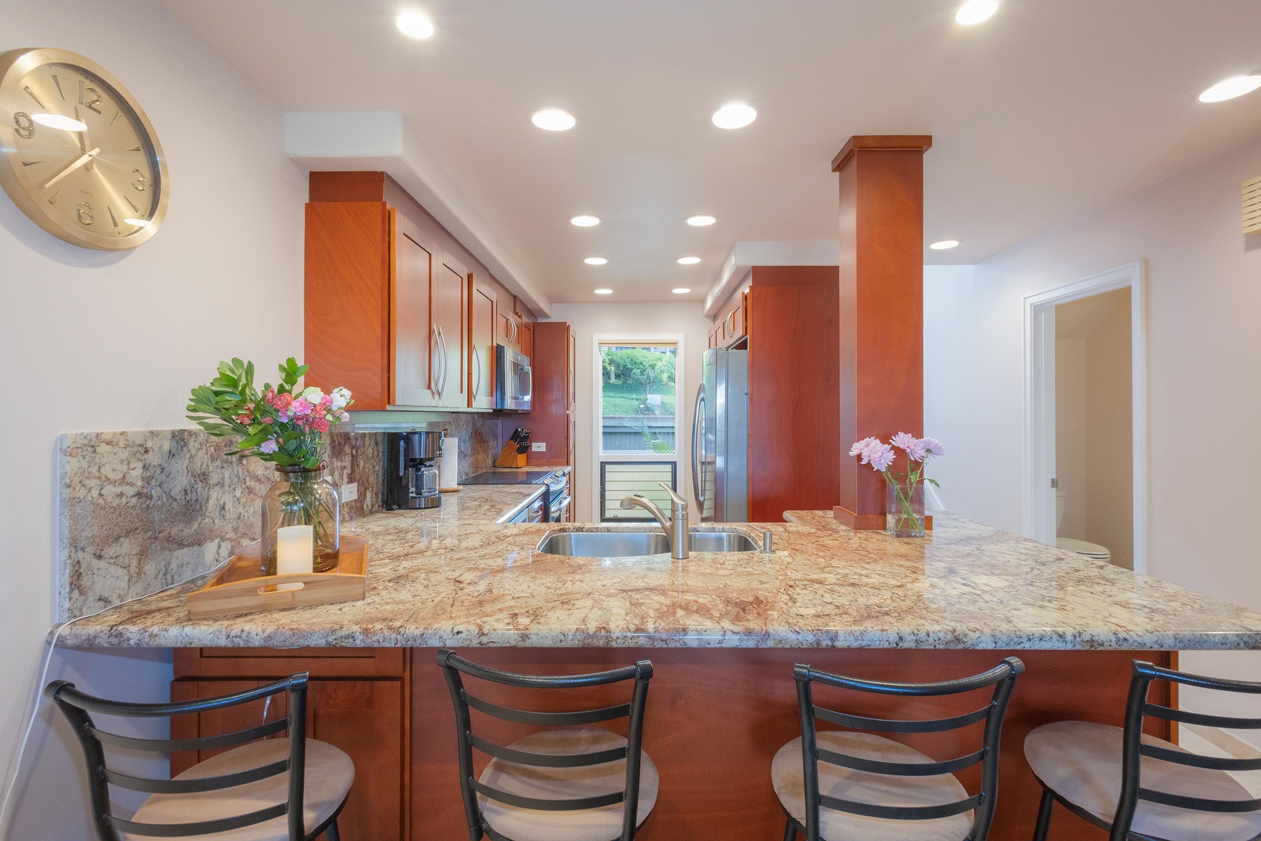 100 Ridge Road, Unit 723 Lahaina, HI 96761 - Photo 9 of 48 a kitchen with a table and chairs in it