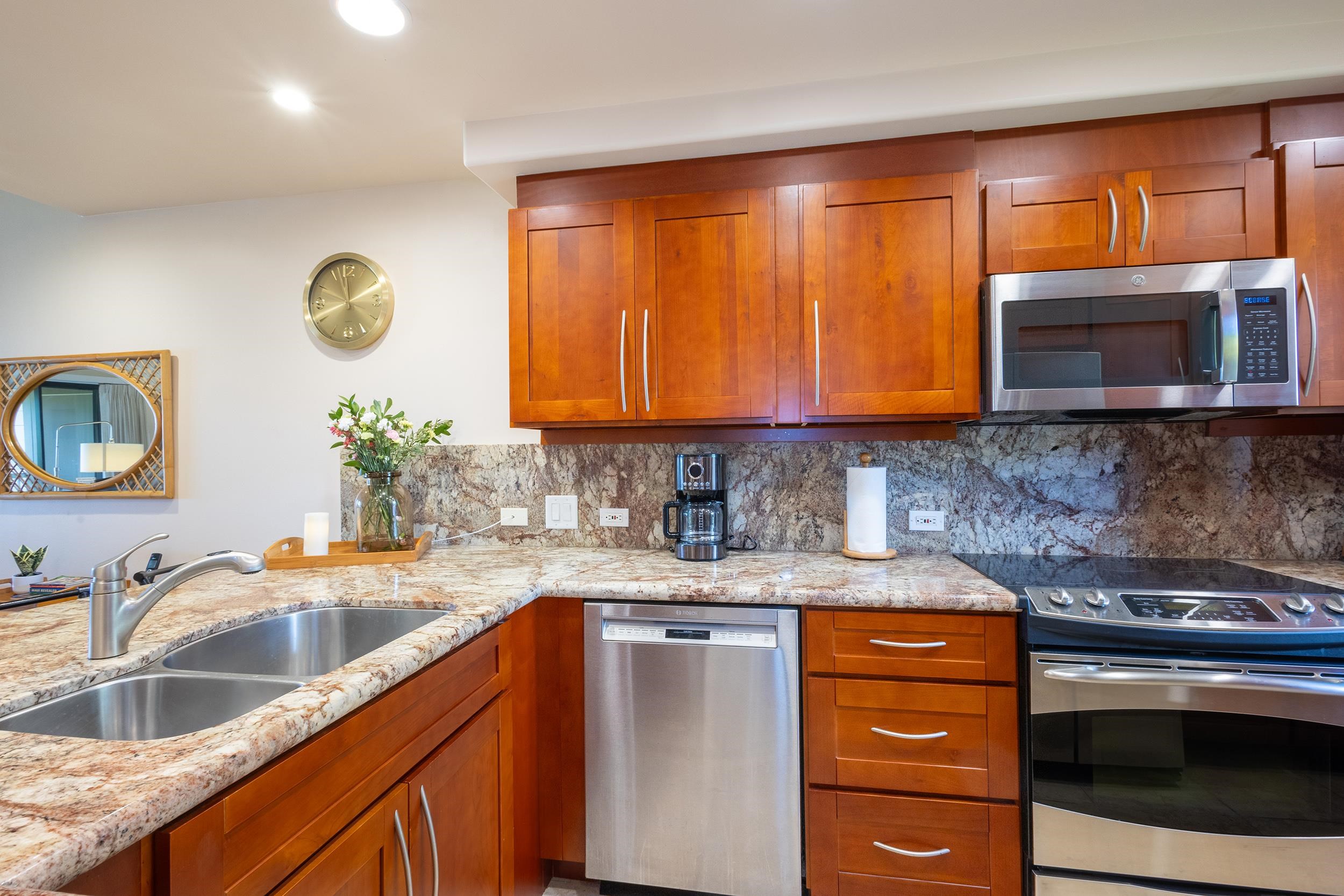 100 Ridge Road, Unit 723 Lahaina, HI 96761 - Photo 10 of 48 a kitchen with stainless steel appliances granite countertop a sink a stove microwave and cabinets