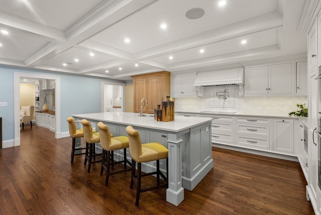 61 Possum Road Weston, MA 02493 - Photo 12 of 42 a kitchen with stainless steel appliances kitchen island granite countertop a table chairs sink and cabinets