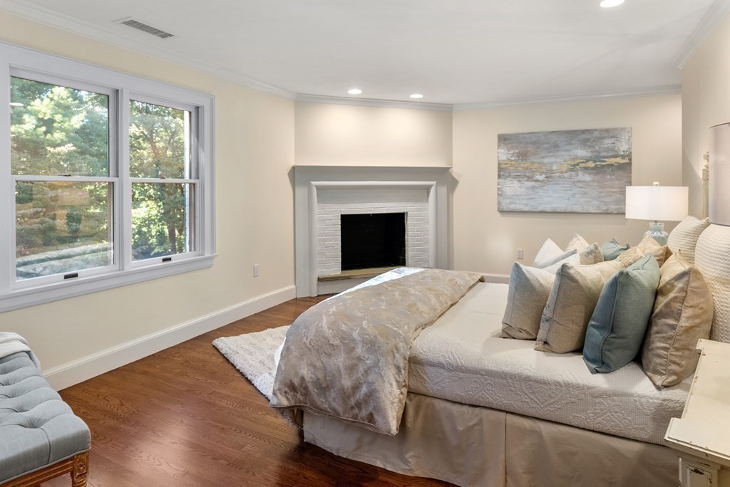 61 Possum Road Weston, MA 02493 - Photo 27 of 42 a bed sitting in a bedroom next to a window