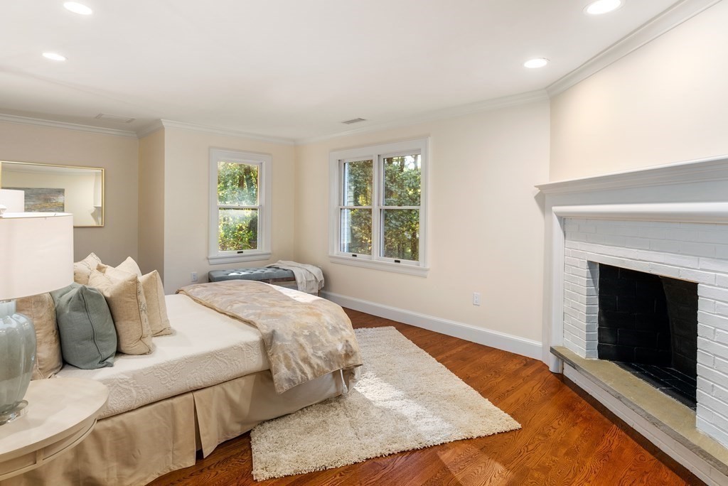 61 Possum Road Weston, MA 02493 - Photo 29 of 42 a bedroom with a bed and a fireplace