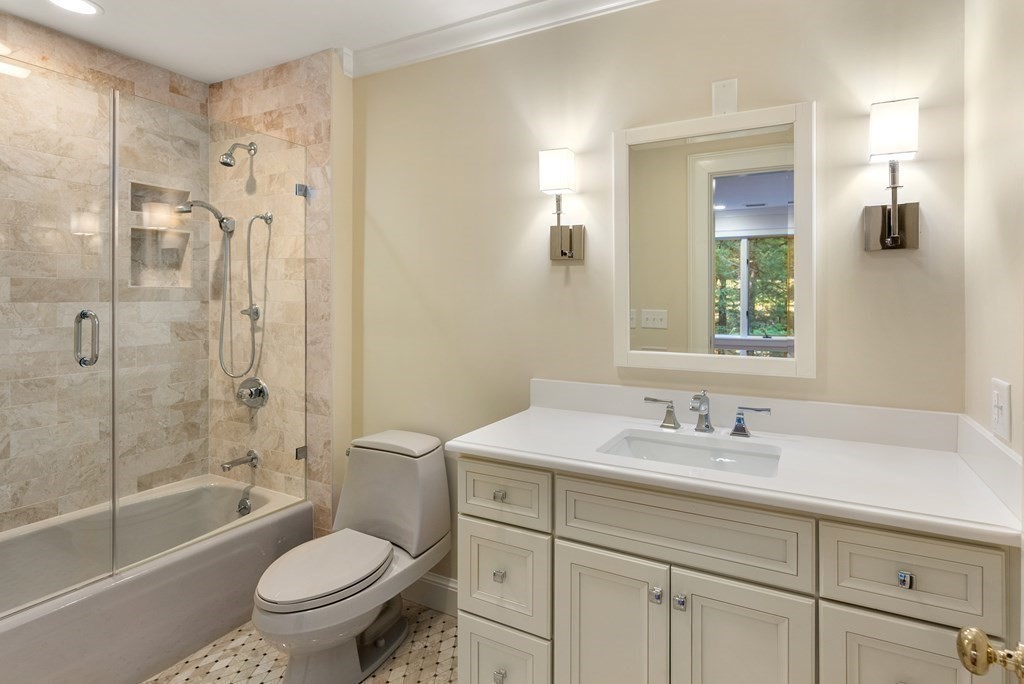 61 Possum Road Weston, MA 02493 - Photo 30 of 42 a bathroom with a sink toilet a mirror and shower