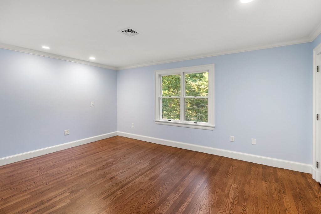 61 Possum Road Weston, MA 02493 - Photo 31 of 42 an empty room with wooden floor and windows