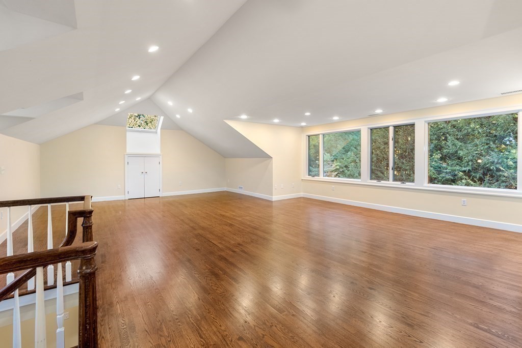61 Possum Road Weston, MA 02493 - Photo 33 of 42 a view of an empty room with wooden floor and a window