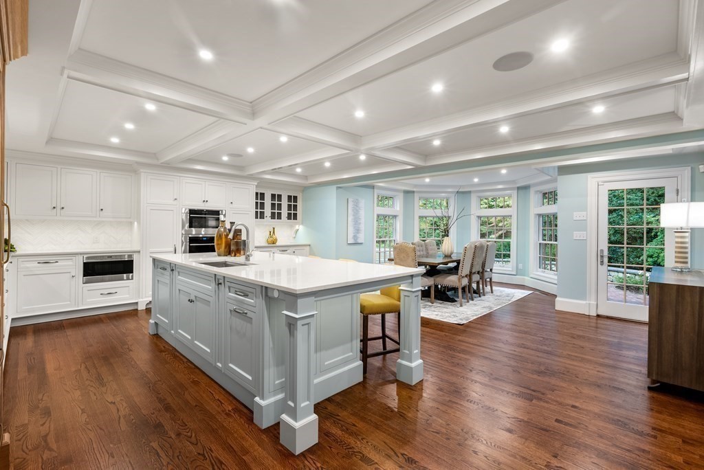 61 Possum Road Weston, MA 02493 - Photo 8 of 42 a large kitchen with stainless steel appliances granite countertop a large center island and a wooden floors