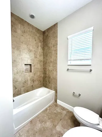 a bathroom with a toilet and a bathtub