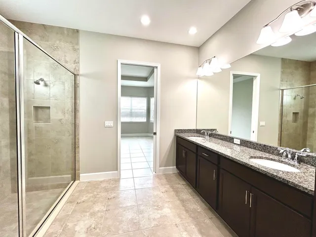 a large bathroom with a granite countertop sink mirror and a
