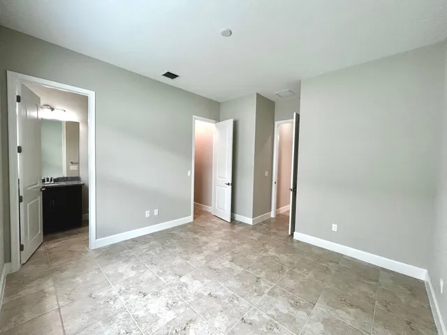 a view of an empty room with a bathroom
