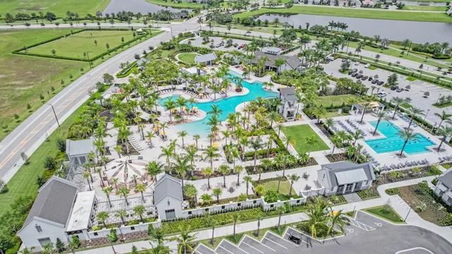 an aerial view of residential houses with outdoor space and swimming pool